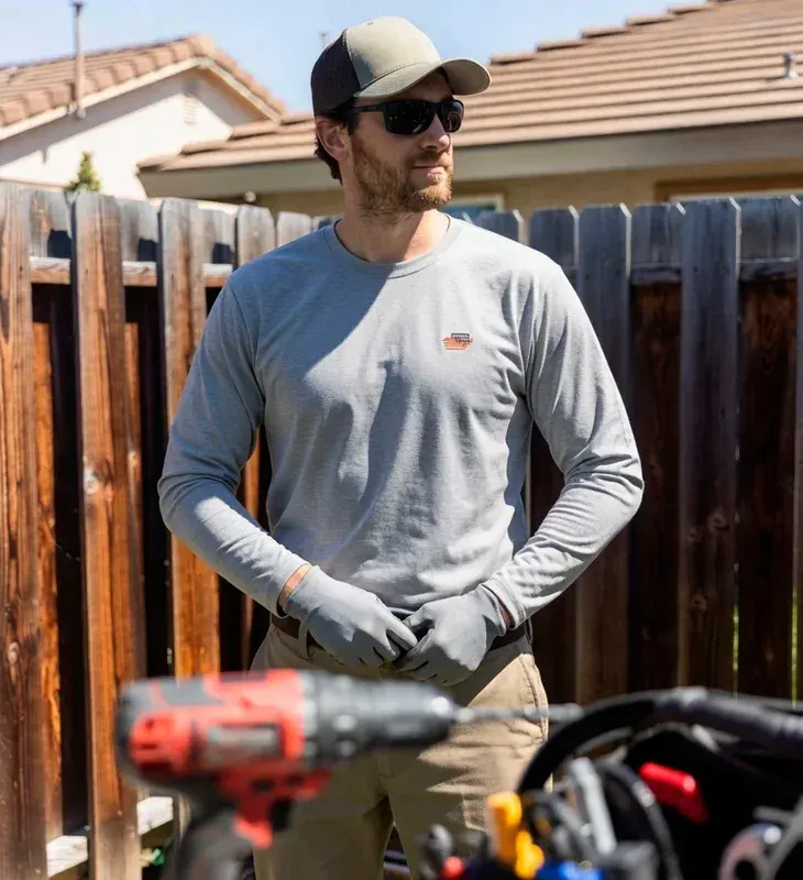 Confident HVAC technician standing with tools in a residential backyard in Chatsworth, California