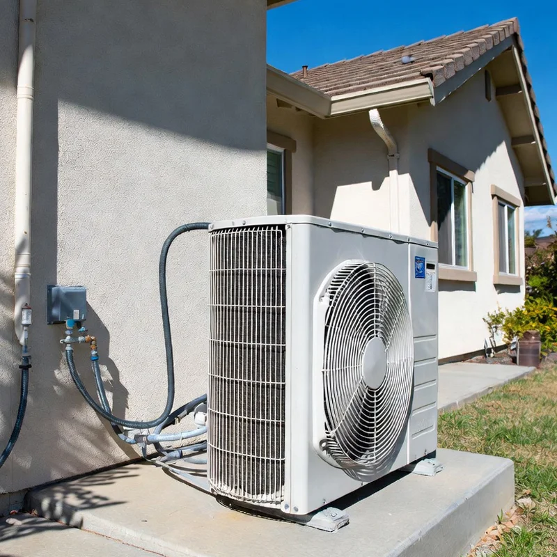 Professional installation of a ductless mini split air conditioner outdoor unit next to a residential home in Los Angeles, CA.