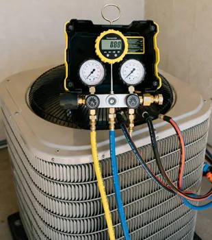 Professional digital manifold gauges connected to outdoor air conditioning unit during service in Westlake Village, California