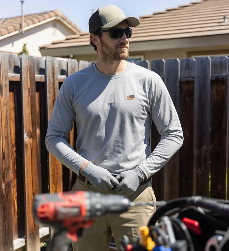 Confident HVAC technician standing with tools in a residential backyard in Chatsworth, California